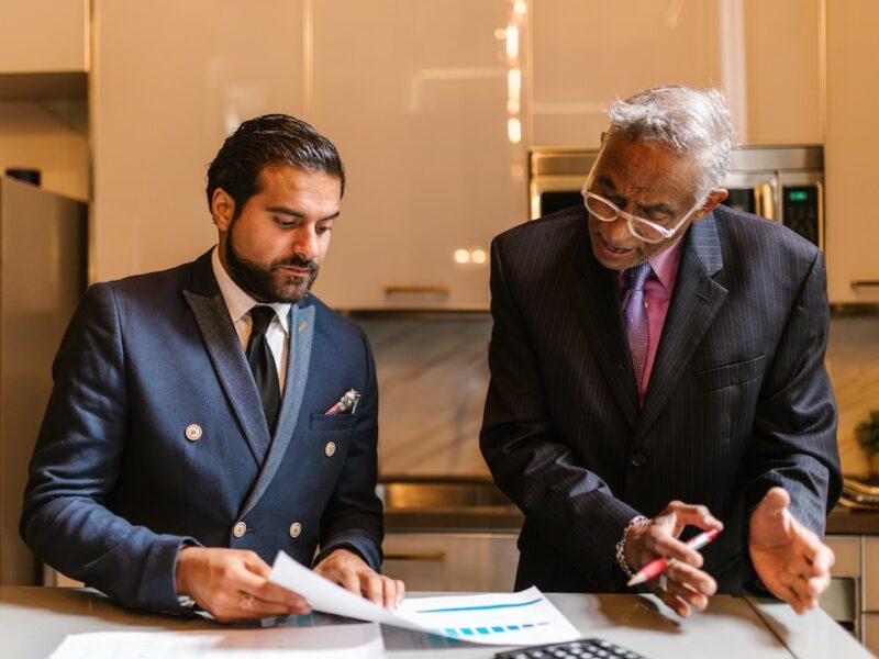 An wrongful death attorney explaining a document to a colleague